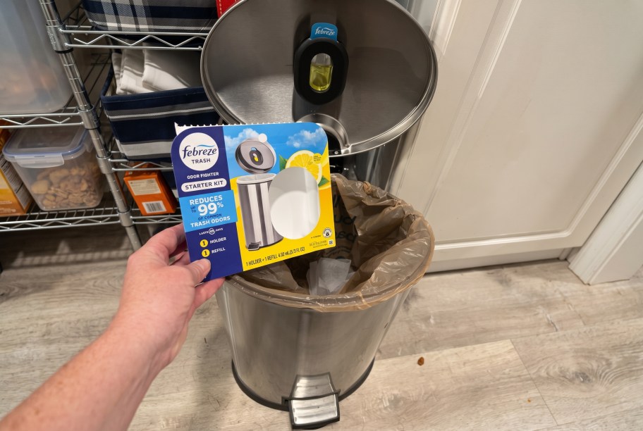 hand holding Febreze Trash Odor Fighter over a trash can