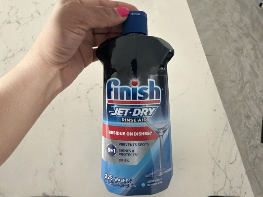 Finish Jet-Dry Dishwasher Rinse 23oz Bottle in hand in kitchen