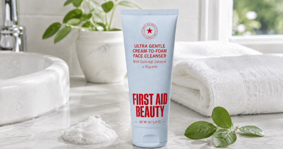 First Aid Beauty face cleanser on a bright bathroom vanity