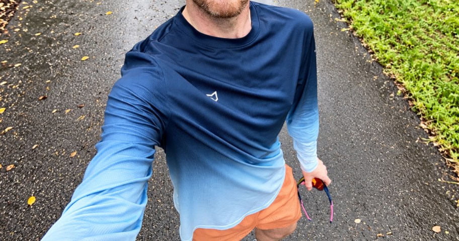 man taking selfie wearing a blue long sleeve shirt