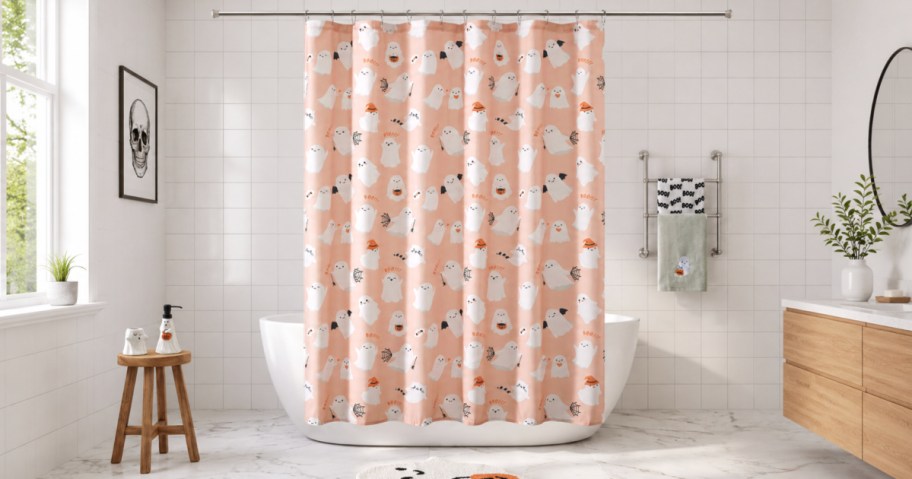 Ghost themed shower curtain hanging off of rod in bathroom