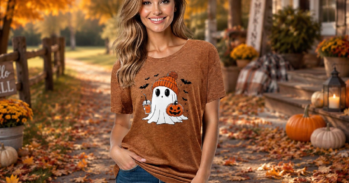 Woman wearing Halloween pumpkin T-shirt, and standing outside with fall background