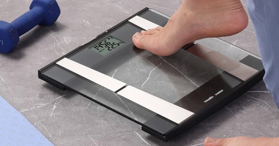 person stepping onto a glass scale