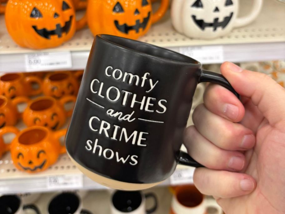 Hyde & EEK! Boutique Comfy Clothes and Crime Shows Mug in hand in store