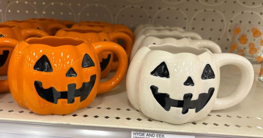 Hyde & EEK! Boutique Orange and white Pumpkin Figural Mugs on shelf in store