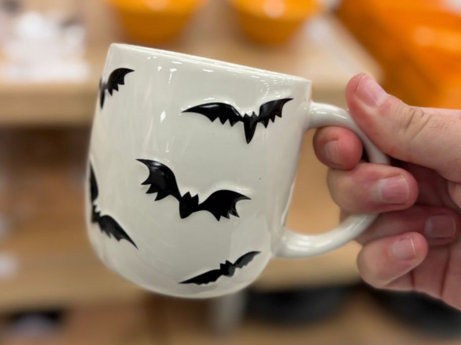 Hyde & EEK! Boutique Scattered Bats Mug in hand in store