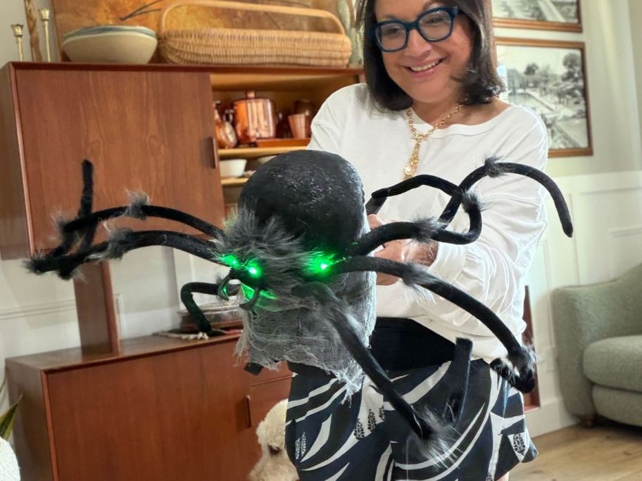 lina holding Hyde and EEK! Boutique 30" Jumping Spider Halloween Decorative Prop