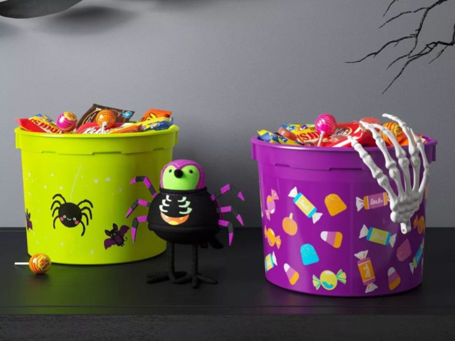 a green and purple Hyde and EEK! Boutique Virgil Resin Halloween Trick or Treat Pail on table