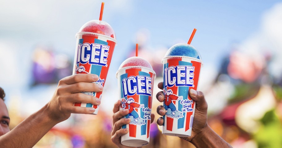 three people holding up ICEE drinks