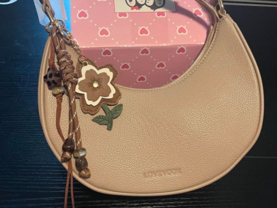 beige Crescent Shoulder Bag on display