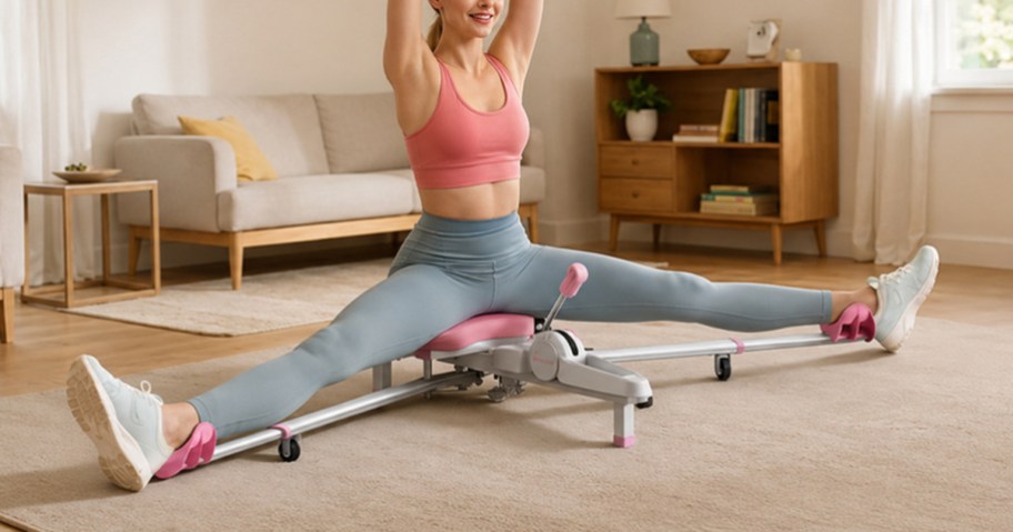 Woman using a pink and white MERACH 180° leg stretcher at home