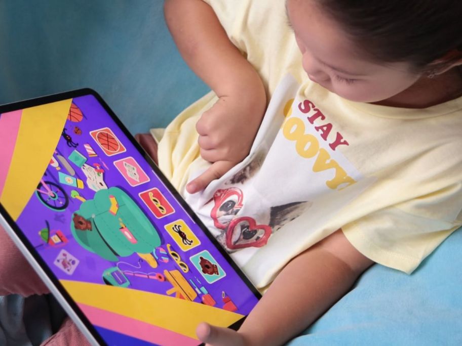 Little girl playing with the LingoKids app on a tablet