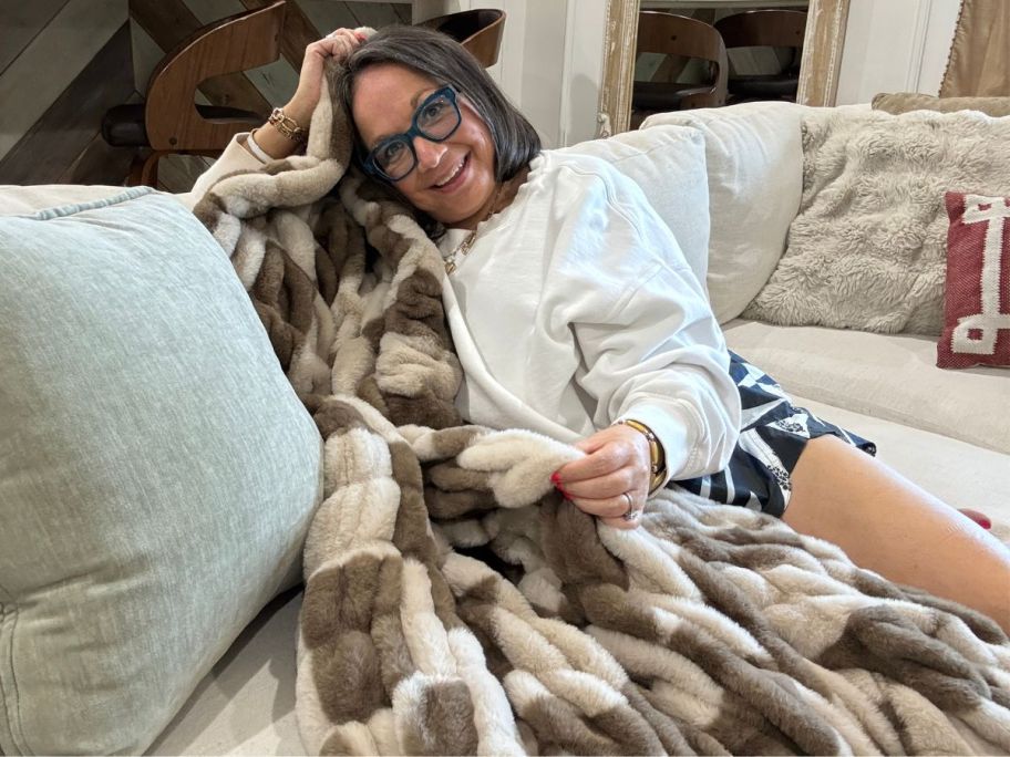 woman on a couch with checkered pattern Lola Faux Fur Blanket