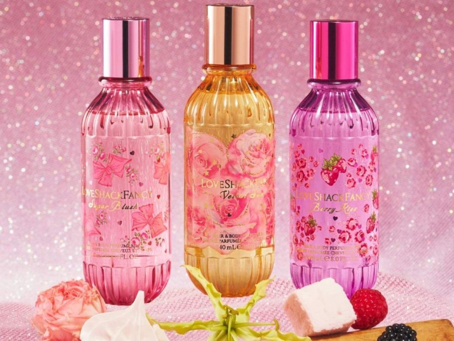 Love shack fancy body and hair mists on top of a table displayed with food on the bottom