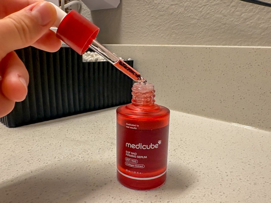 Medicube Firming Serum being used on a counter