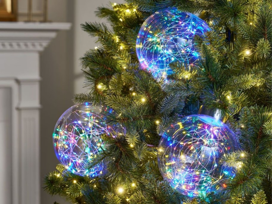 twinkling globe lights hanging in a christmas tree