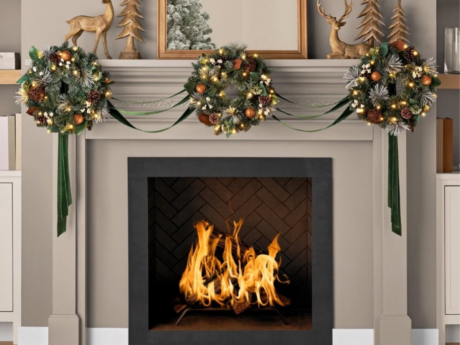 set of 3 weraths with ribbon decorating a mantle