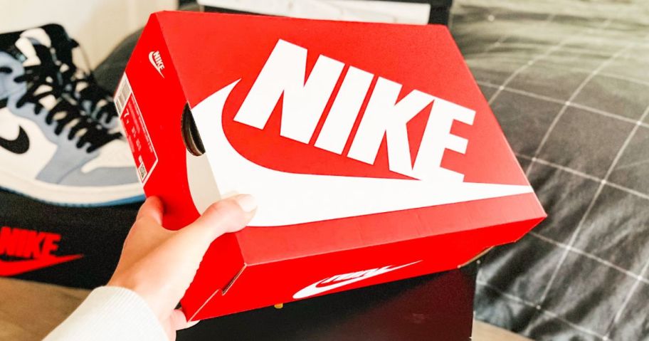 Hand holding a Nike Shoe Box