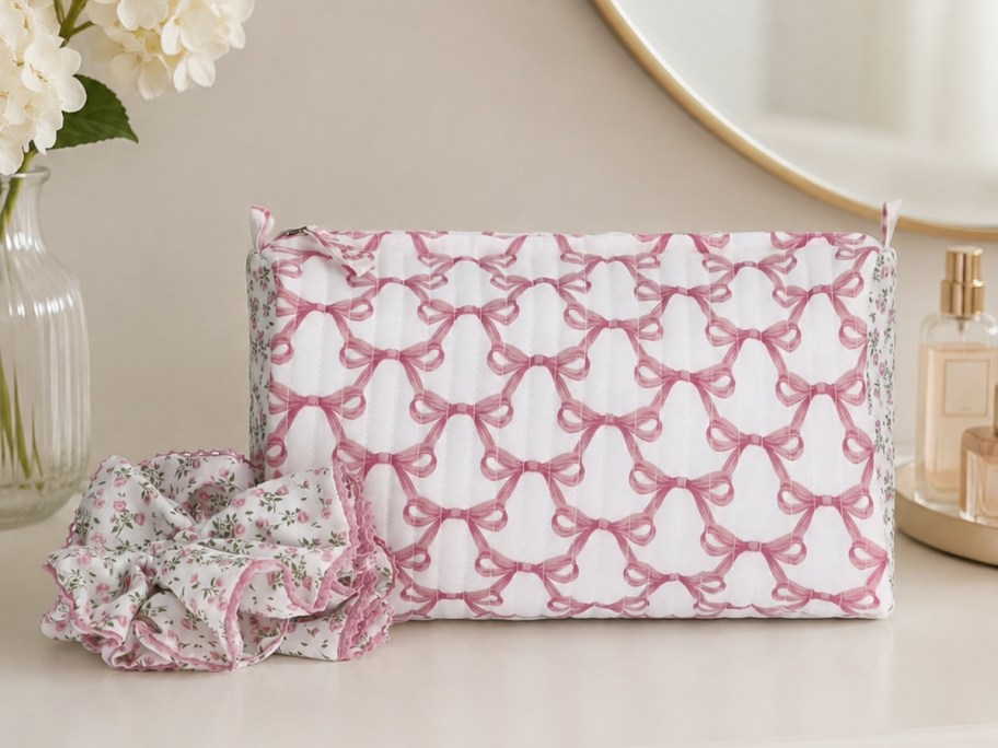 no boundaries quilted pouch with scrunchie in a pink design sitting on vanity