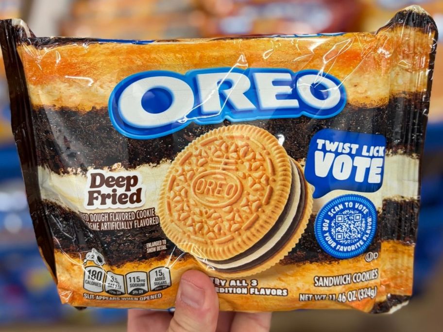 Hand holding a pack of Deep Fried flavored OREO cookies