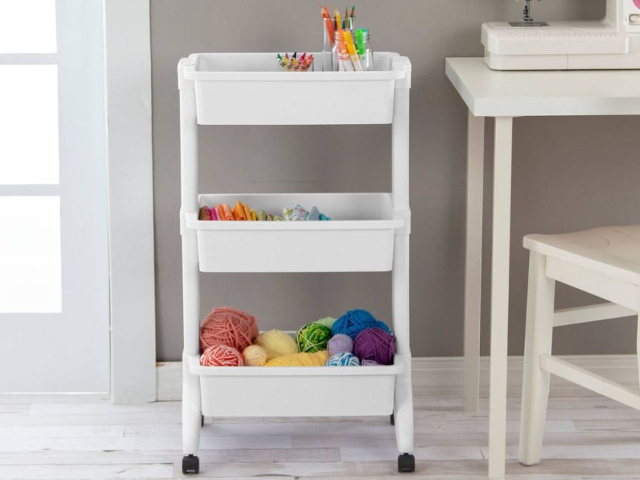 Organization rolling cart with supplies and yarn on it 