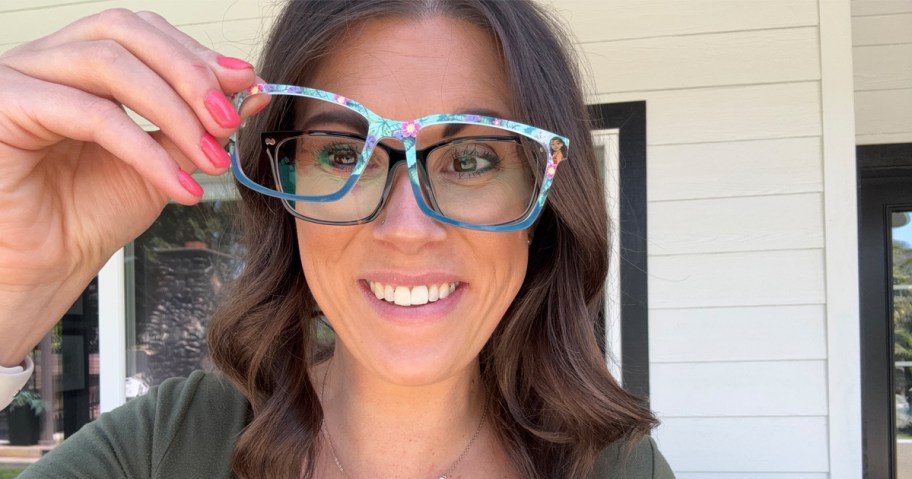 woman holding toppers up to her glasses