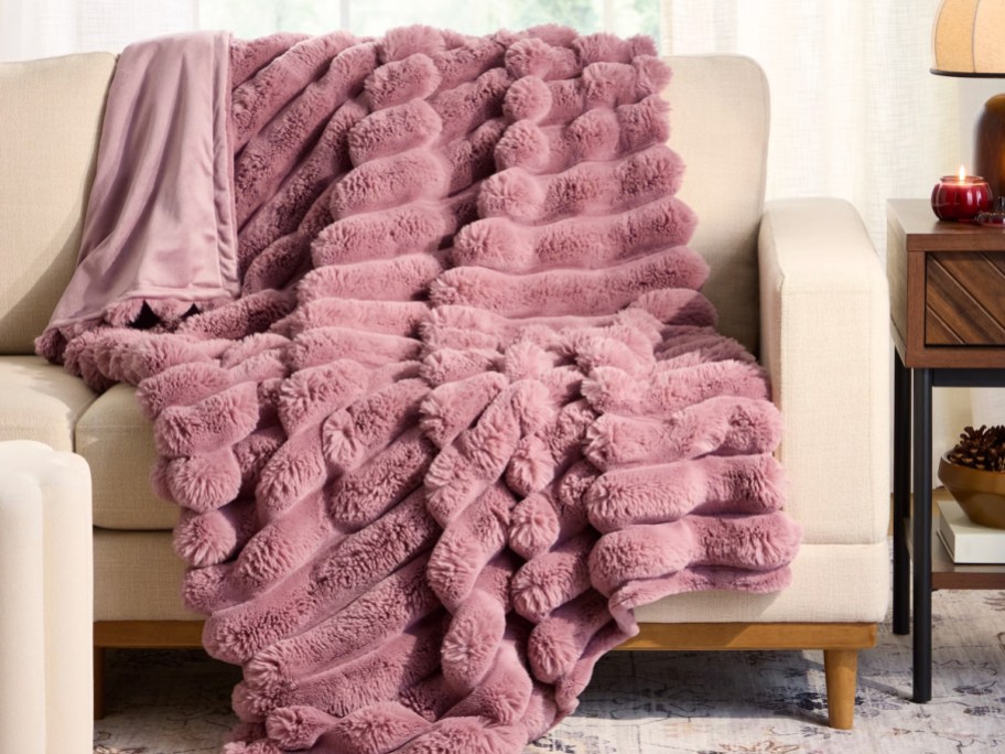 Pink colored bubble throw draped over beige living room chair