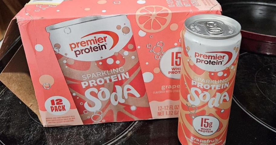 case of premier protein sparkling protein soda with can sitting on stovetop