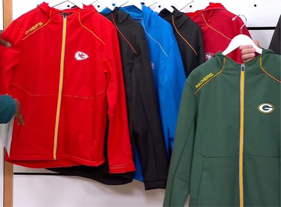 6 NFL Softshell Hooded jackets featuring different teams on hangers