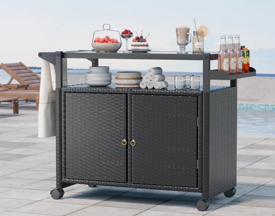 a grey wicker bar cart
