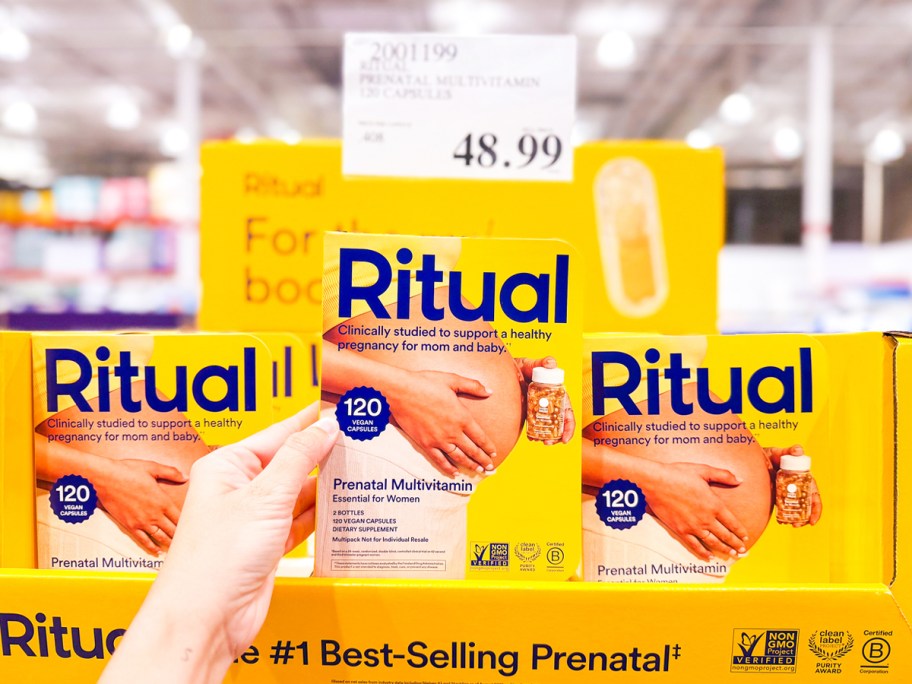 hand holding up a yellow pack of Ritual Essential Prenatal vitamins in Costco