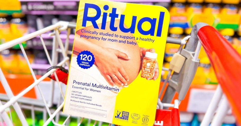 A costco cart with a 2-pack of Ritual Prenatal Vitamins in it