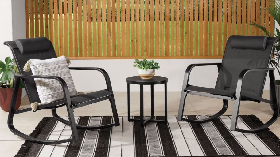 Rocking chairs in black with striped rug on the floor