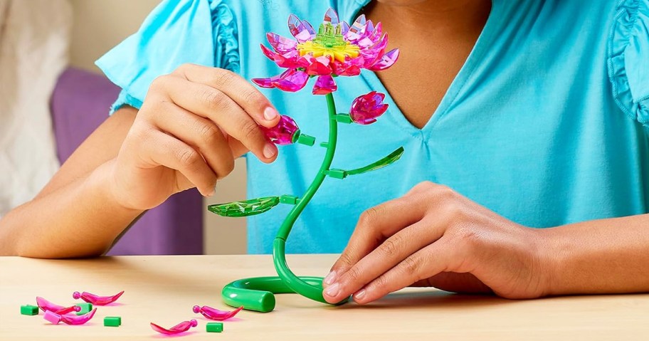girl building a pink lotus crystal gem flower