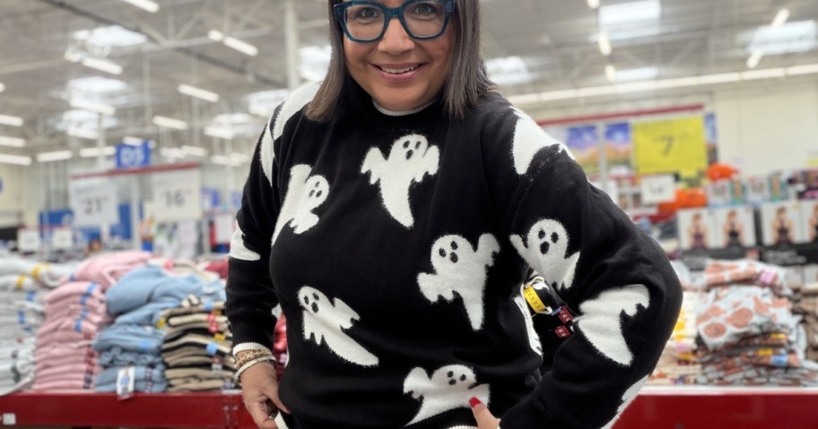 woman wearing black sweater with white ghosts in store