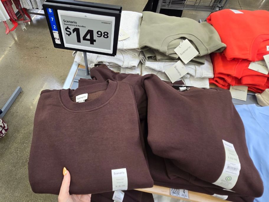 Scenario Sweatshirts & Hoodies on table in store