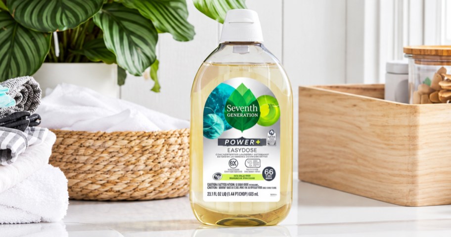 bottle of Seventh Generation Laundry Detergent near folded laundry and wooden organizer bin