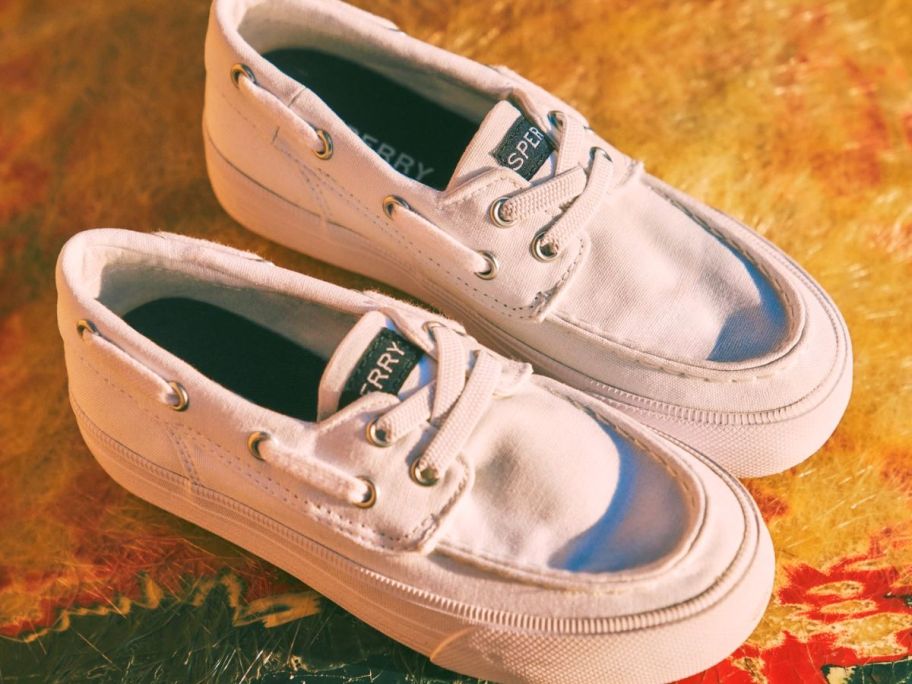 A pair of white sperry Bahama shoes