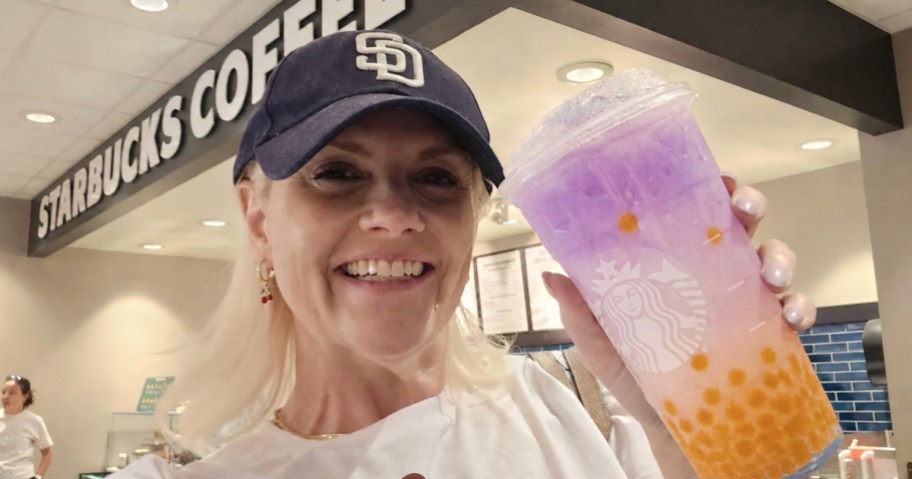Woman holding up colorful Starbucks, iced drink filled with popping Boba's