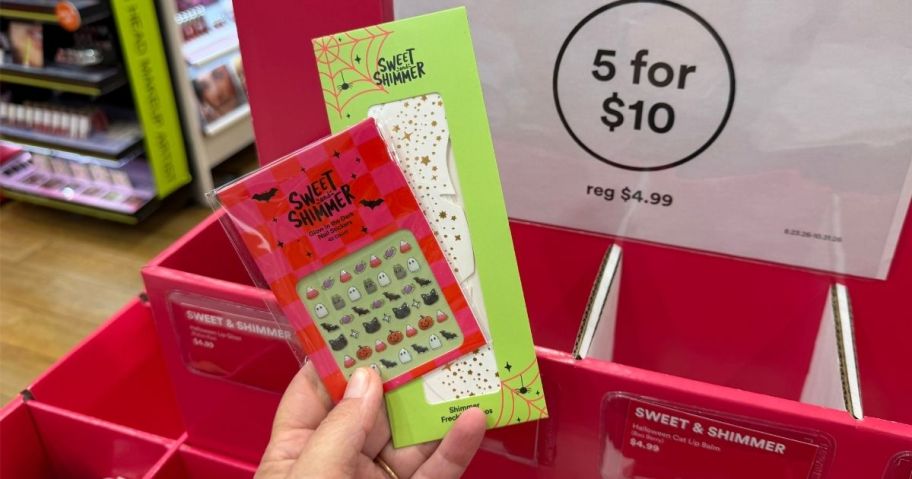 hand holding two pieces from Ulta Sweet & Shimmer Halloween collection in store