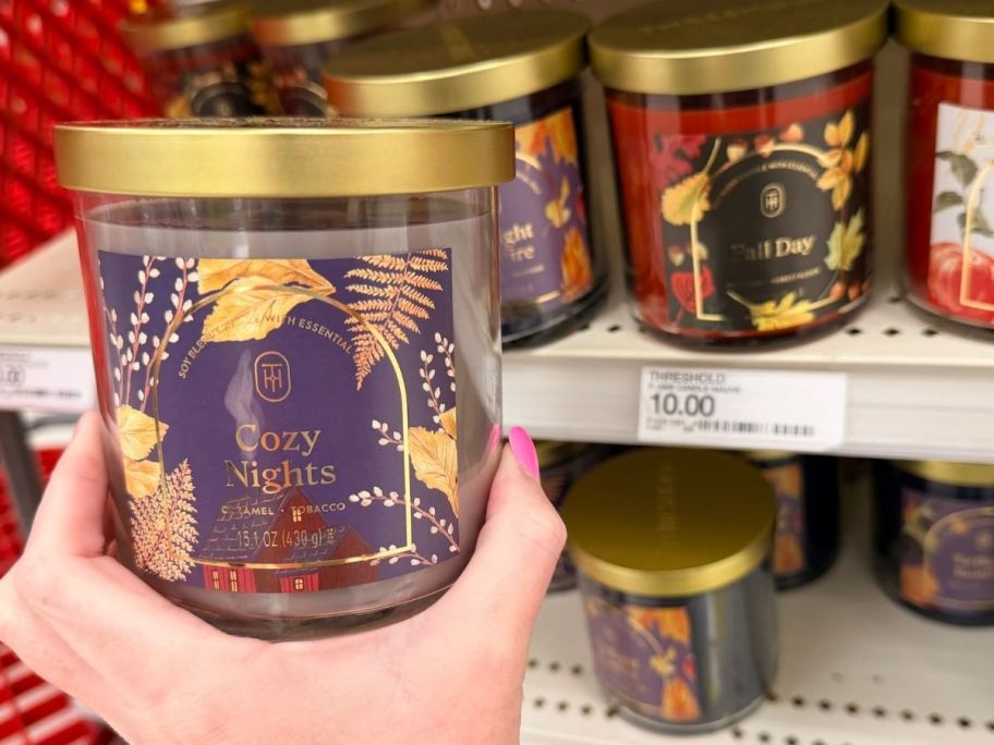 hand holding Threshold 2-Wick Glass 15.1oz Candle in store