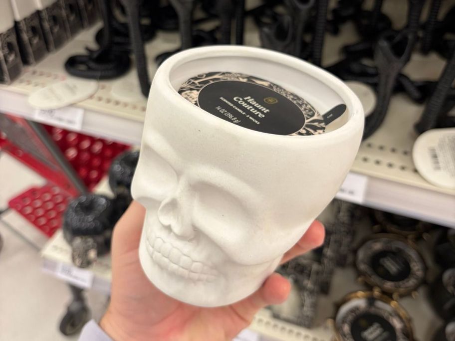 Threshold 2-Wick Large Ceramic Skull Haunt Couture Halloween Jar Candle in hand in store