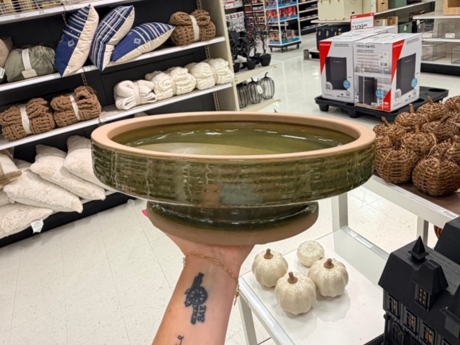 holding a green ceramic bowl