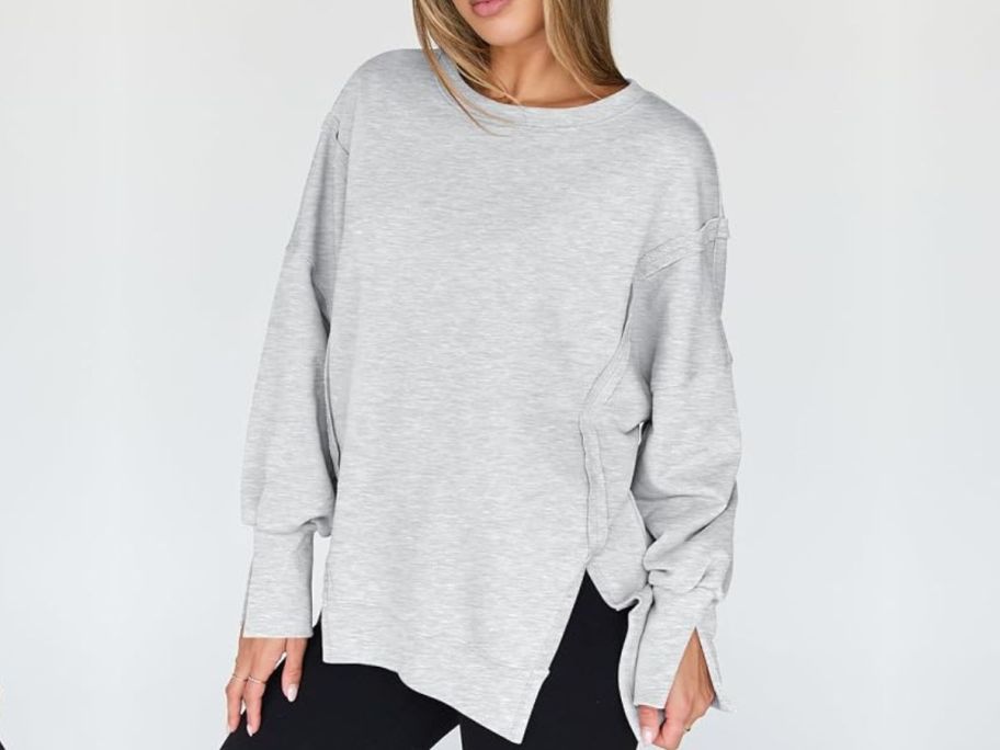 Woman wearing a light gray trendy queen sweatshirt