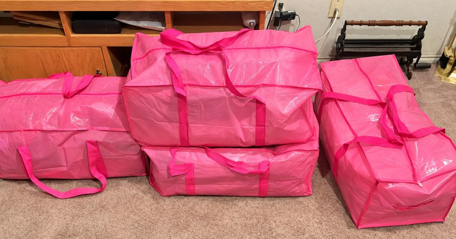 stacked pink moving bags in living room
