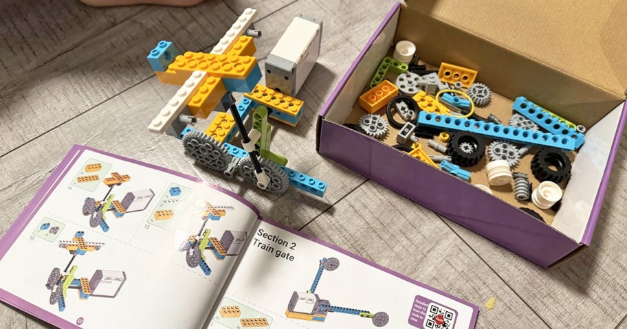 instruction booklet, parts, and build on a floor