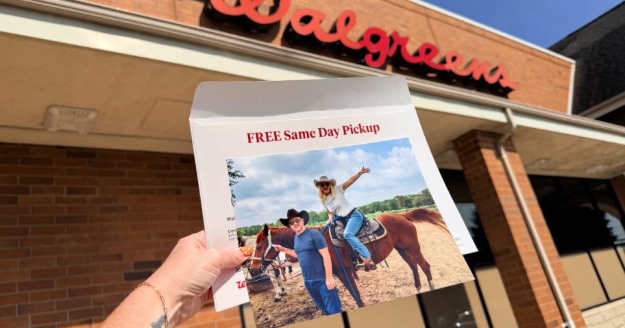 Hand holding 8 x 10 photo print outside of Walgreens store