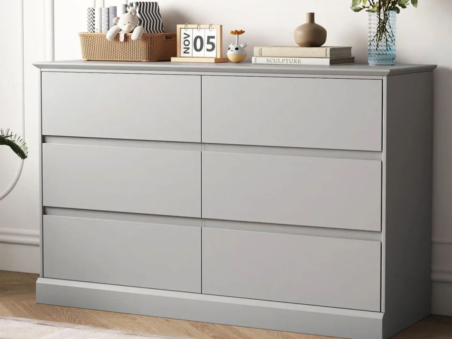 A gray 6-drawer dresser