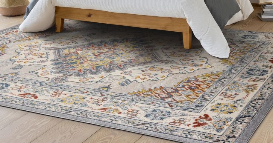 A wayfair rug in a bedroom partially under a bed