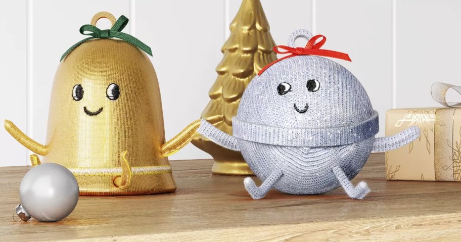 gold and silver bell figurines holding hands